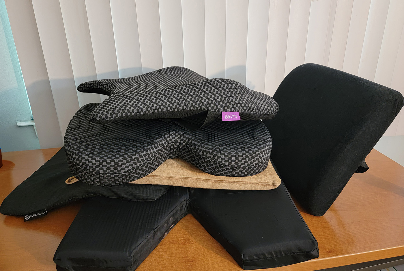 office chair support cushions piled up on a desk